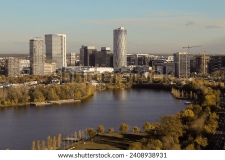 Bucharest from above, aerial view over Herastrau (King Michael I) Park, lake and the north part of the city with office building photographed during a autumn day after sunrise. Royalty-Free Stock Photo #2408938931
