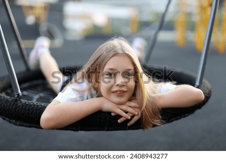 Adorable girl enjoying a summer vacation at the park, experiencing joy and happiness in the playful atmosphere. Royalty-Free Stock Photo #2408943277