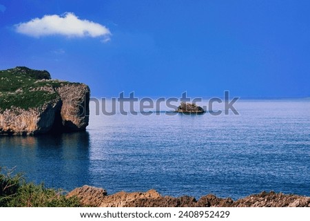 Small island on the rocky coast of Cantabria, Spain