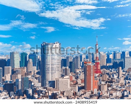 An expansive view capturing a jungle of buildings overseeing the cityscape of Roppongi and Hamamatsucho featuring the striking Roppongi Hills and Tokyo Tower, two landmarks skyscrapers of modern Japan Royalty-Free Stock Photo #2408955419