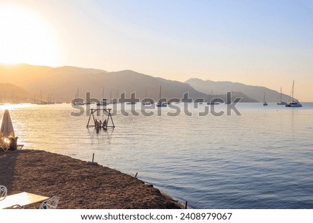 Beautiful sunrise on the sea in a resort town. Background with selective focus and copy space for text.