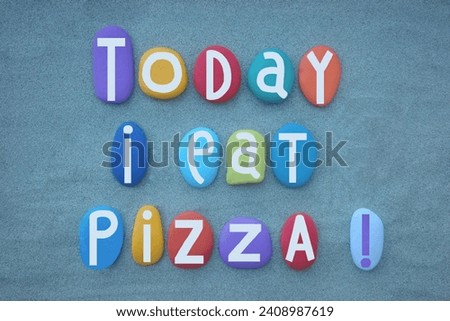 Today I eat pizza, creative slogan composed with hand painted multi colored stone letters over green sand