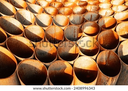 Rusty iron, Symmetrical metal pipes under the sun, with light shadow