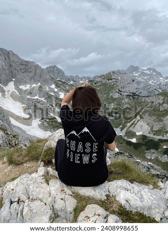 Woman Enjoying Hiking in Snowy Mountain Landscape Sitting and Looking Afar Travel Wearing T-shirt Chase Views