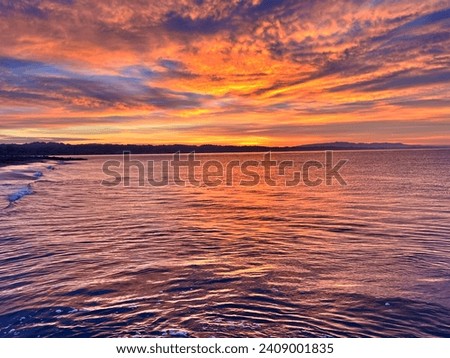 A purple pink, orange sunrise in Capitola Village right off Monterey Bay, California ￼ Royalty-Free Stock Photo #2409001835