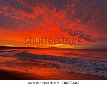 Red sky in the morning. Sunrise in a small coastal village off the Monterey Bay in California. Royalty-Free Stock Photo #2409002367