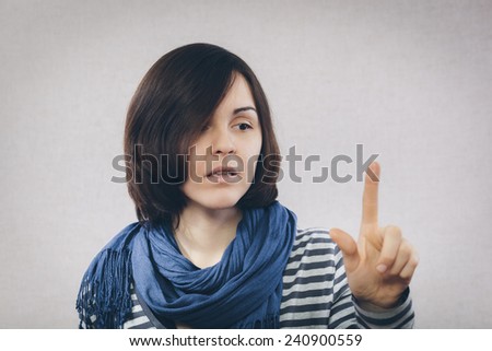 a young girl looks at the finger