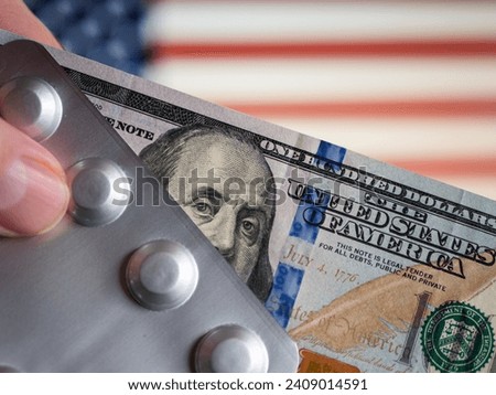 100-Dollars Holding Tablet Packaging with US Flag Background