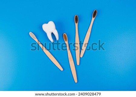 Tooth and eco tooth brushes on a blue background. Concept of dental examination of teeth, health and dental hygiene. Prevention of caries and tartar teeth.