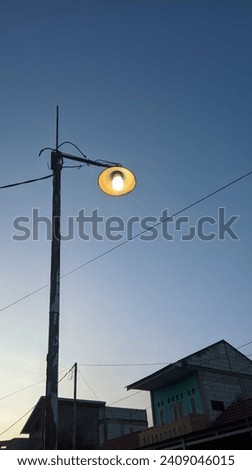 photo of a street lamp and several houses behind it 