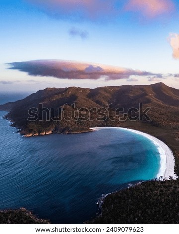 a view of wineglass bay from Mount Amos at sunset Royalty-Free Stock Photo #2409079623
