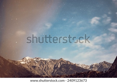 Stars on Sky at evening above the mountains. A long exposure picture that prominents clouds, mountain and stars