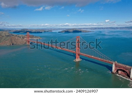 The iconic Golden Gate Bridge stretches across the San Francisco Bay, a monument of engineering beauty captured from above by a drone, with the Pacific Ocean's azure waters. Royalty-Free Stock Photo #2409126907