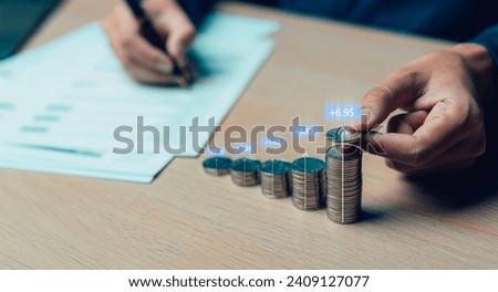 businessman putting stack of coins into one row Percent sign for finance, return on investment, credit, mortgage, banking, tax, marketing, percentage for interest rating from growth investment.
