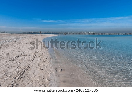 Clear water reflections on shallow sandy beach bottom. UAE Jumeirah beach