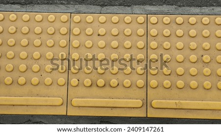 Macro or close-up photo of rubber guiding block, yellow guiding block for disabilities