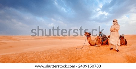 MERZOUGA, MOROCCO - 2023 dromedary with his owner in the desert
