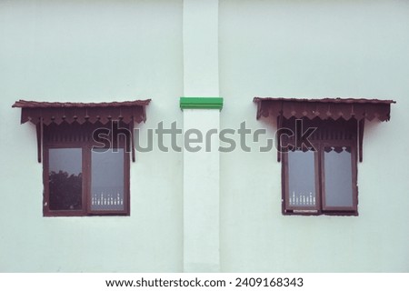 two windows on a white wall