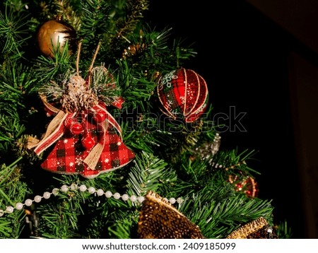 Christmas ornament on the pine tree with black background.