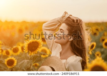 Woman in Sunflower Field: Happy girl in a straw hat posing in a vast field of sunflowers at sunset, enjoy taking picture outdoors for memories. Summer time.