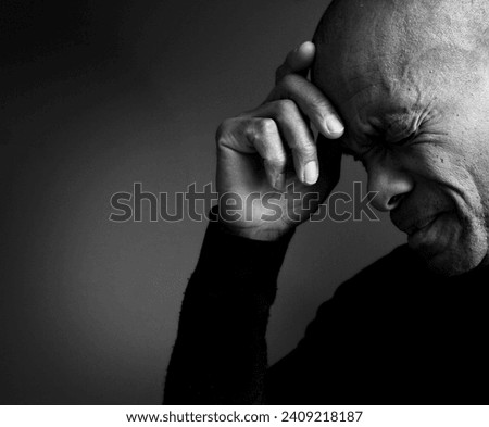 man praying to god Caribbean man praying with black background with people stock photo