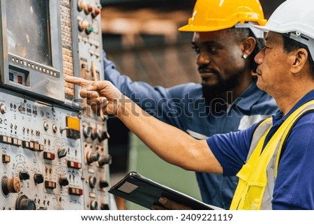 Industrial worker indoors in old factory. Industrial man Engineers in Hard Hats.Work at the Heavy Industry Manufacturing Factory. Royalty-Free Stock Photo #2409221119