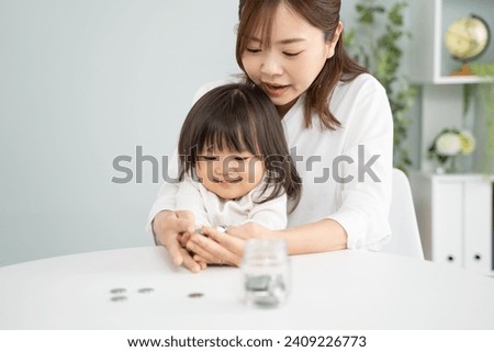 Parents and children learn the importance of investing and saving Royalty-Free Stock Photo #2409226773