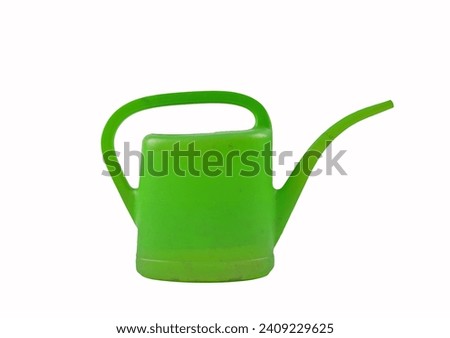 Green watering can isolated on white background Royalty-Free Stock Photo #2409229625