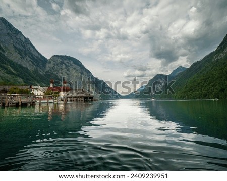 A boat ride though the Berchtesgaden Kingslake with a view to the mountain valley with the church as a unique symbol