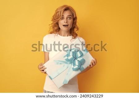 surprised redhead girl with gift box. boxing day
