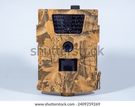 Hunting trail camera on a white background. Photo and video trap. A battery operated camera that can be attached to a tree trunk