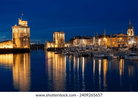 beautiful illuminated cityscape of the old harbor of La Rochelle at night with festive ciyilights