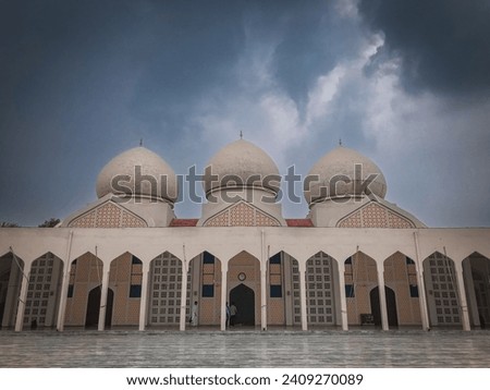 Landscape photo of a beautiful white Masjid (Mosque). Prefect photo for Ramdan background.  Royalty-Free Stock Photo #2409270089