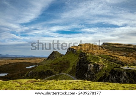 Landscape photography of the Scottish Highlands in the fall. Beautiful scene with mountains and green grass  Royalty-Free Stock Photo #2409278177