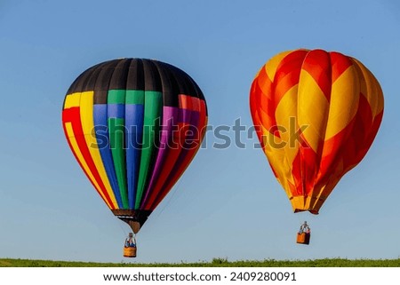Dazzling balloons dance in the blue sky, a vibrant spectacle of colors floating joyfully across the heavens