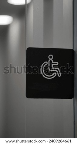 Handicapped sign on a glass door.