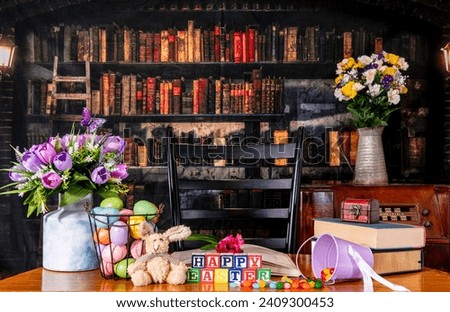 Happy Easter in wood blocks with spring flowers jelly beans and colored eggs with old library background