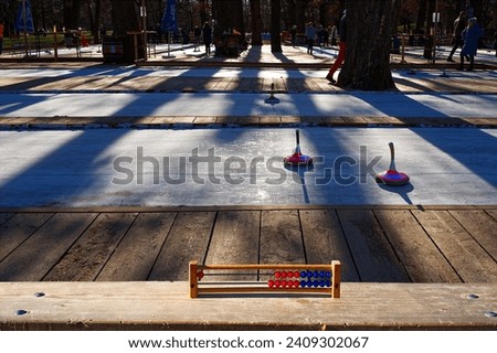An abacus to count the score of the curling against the icerinks in sunlight and shadows Royalty-Free Stock Photo #2409302067
