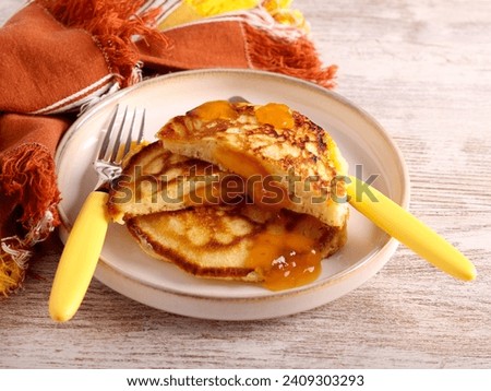 Jam filling pancakes on plate Royalty-Free Stock Photo #2409303293