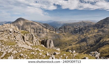 Panorma looking down from the summit of Scafell Pike towards Styhead Tarn and Borrowdale, with the summit of Great Gable on the left, Lake District, UK Royalty-Free Stock Photo #2409309713