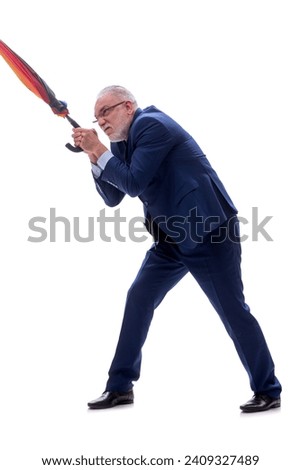 Old businessman holding an umbrella isolated on white