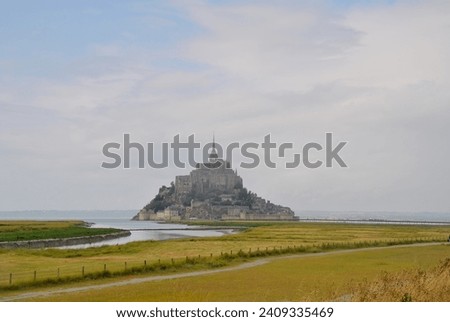 The very traditional picture depicting Mont-Saint-Michel in France is taken shortly after the passage of a severe rainy storm, which makes the coloirs of the land and of the sky even brighter.