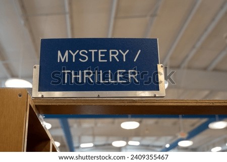 A sign at a book store that indicates the "mysterythriller" section.