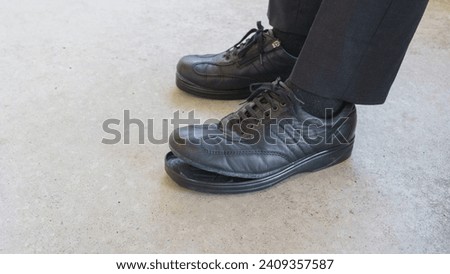 The soles of my business shoes are peeling off.A businessman in a suit. Royalty-Free Stock Photo #2409357587