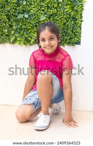 Portrait of cute looking indian girl enjoying and posing in shopping mall.
