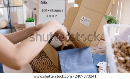 Eco vendor go green packaging parcel carton box in net zero waste store asian seller retail shop. Earth care day small SME owner asia people wrap reuse brown paper pack gift reduce plastic free order.