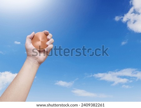 holding a bronze coin on the sky background Winner and success concept