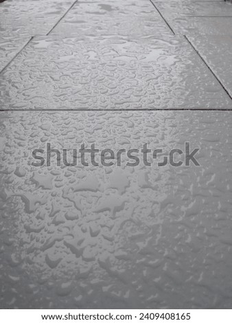 rainwater splashes on the terrace floor of the house