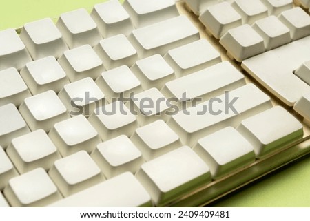 Closeup view of a computer keyboard on a colored background