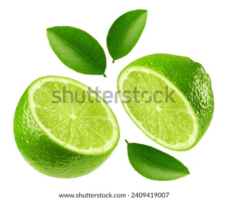 Lime isolated. Two halves of ripe lime with leaves on a white background. Fruit levitation. Royalty-Free Stock Photo #2409419007